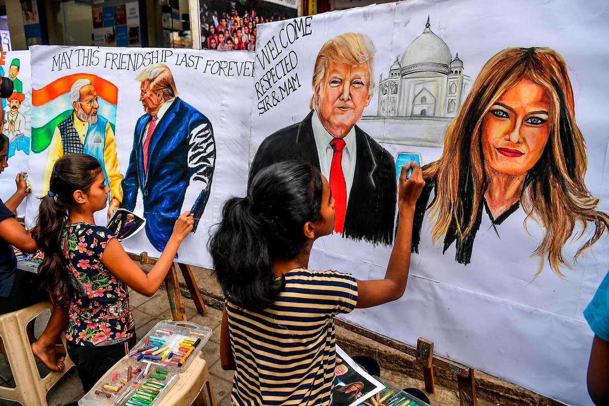 TOPSHOT - Students paint on canvas faces of US President Donald Trump (C), his wife Melania (R), and India's Prime Minister Narendra Modi (L) in the street in Mumbai on February 21, 2020, ahead of the visit of US President in India. (Photo by INDRANIL MUKHERJEE / AFP) (Photo by INDRANIL MUKHERJEE/AFP via Getty Images)