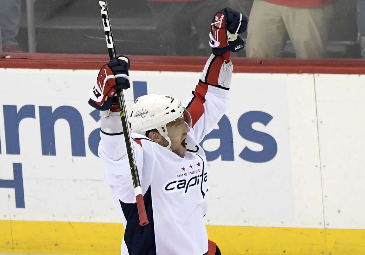 Washington Capitals left wing Alex Ovechkin (8) celebrates his 700th career goal during the third period of an NHL hockey game against the New Jersey Devils Saturday, Feb. 22, 2020, in Newark, N.J. (AP Photo/Bill Kostroun)
