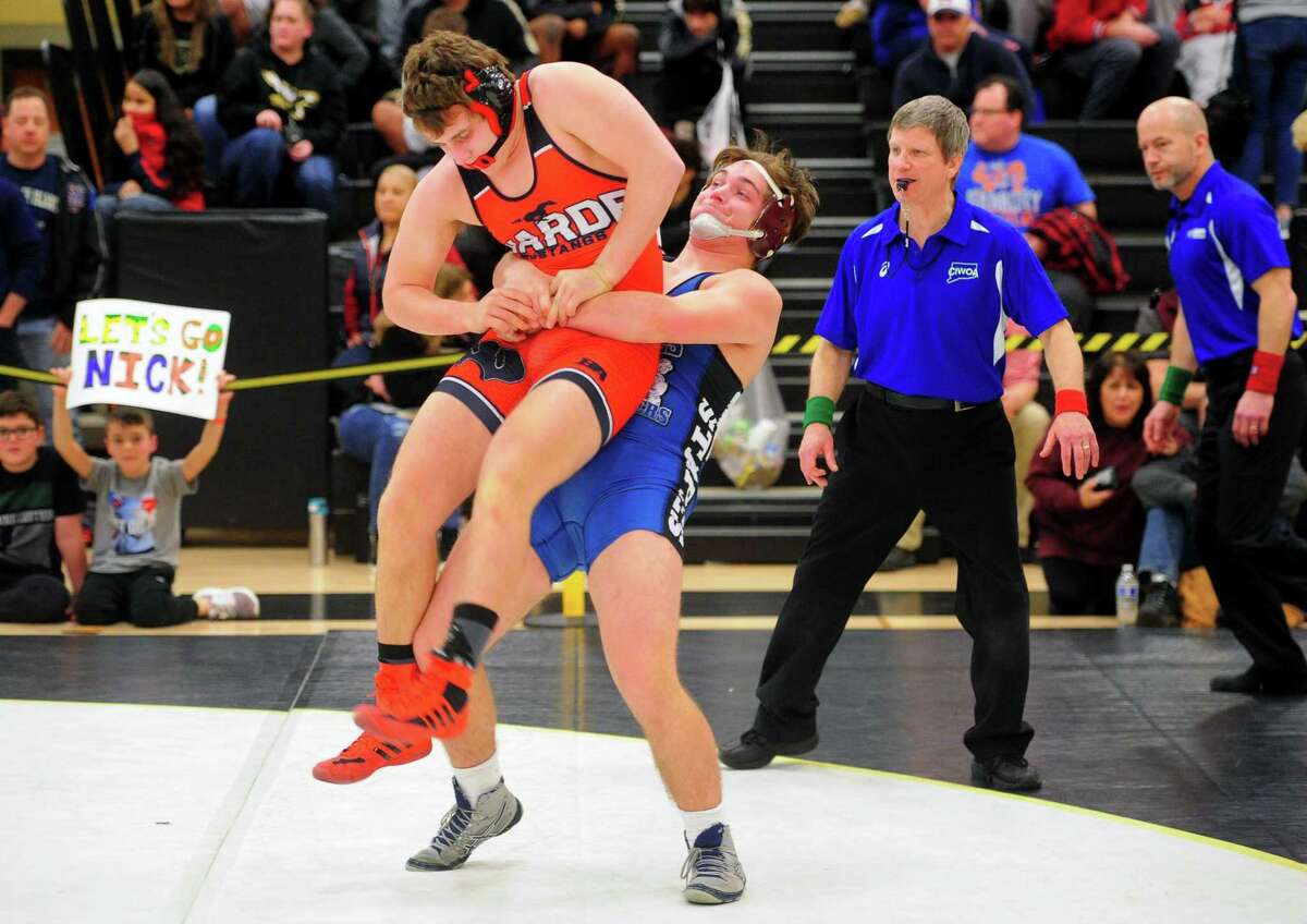 Staples’ Nicholas Augeri lifts Fairfield Warde’s Griffin Gallati off the mat during the Class LL championship on Saturday.