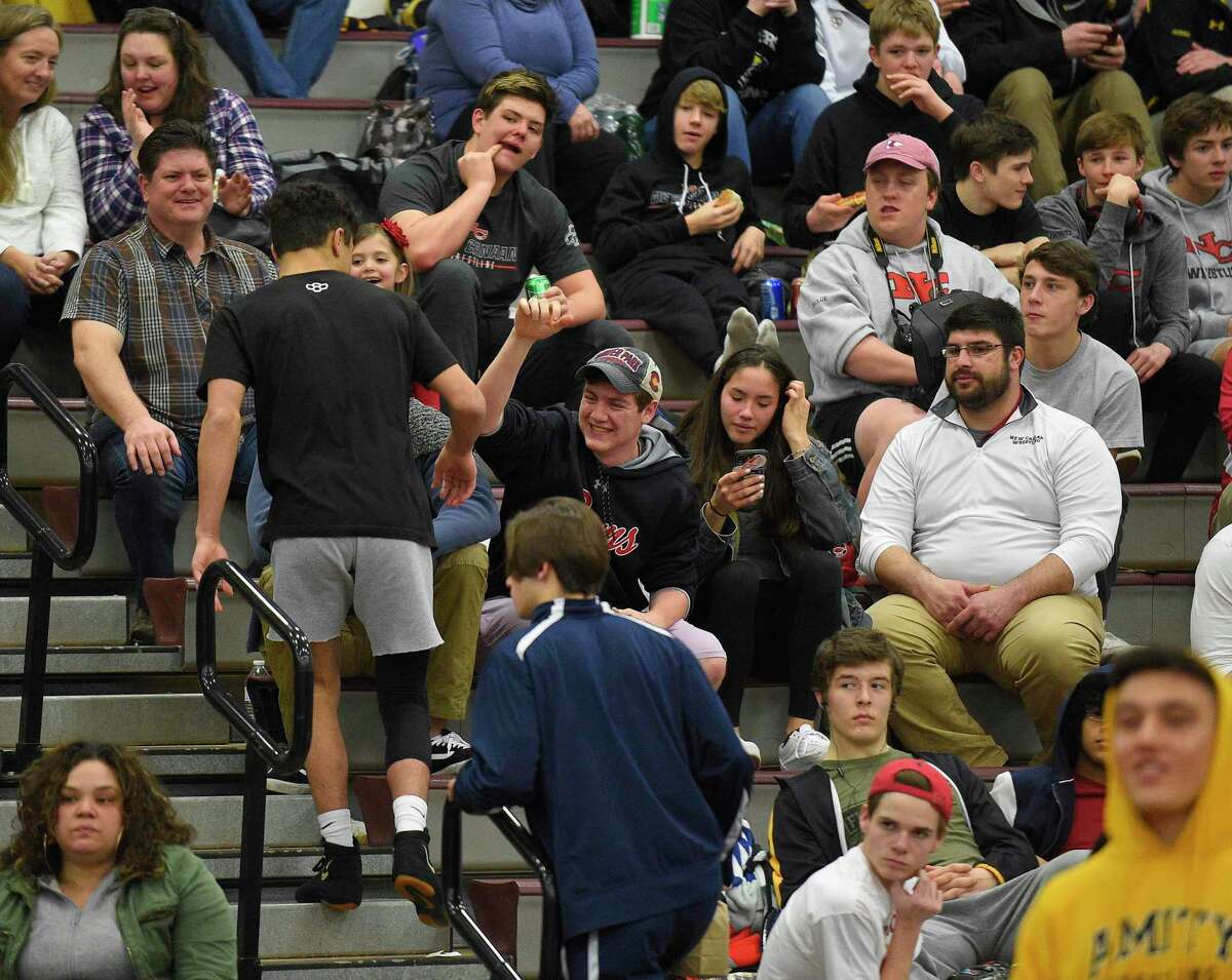 New Canaan's Tyler Sung, sits with his fans following introductions. He will wrestle Xavier's Quinn Moynihan in the 152 pound weight class finals of the CIAC Class L Wrestling tournament on Feb. 22, 2020 at Bristol Central High School in Bristol, Connecticut.