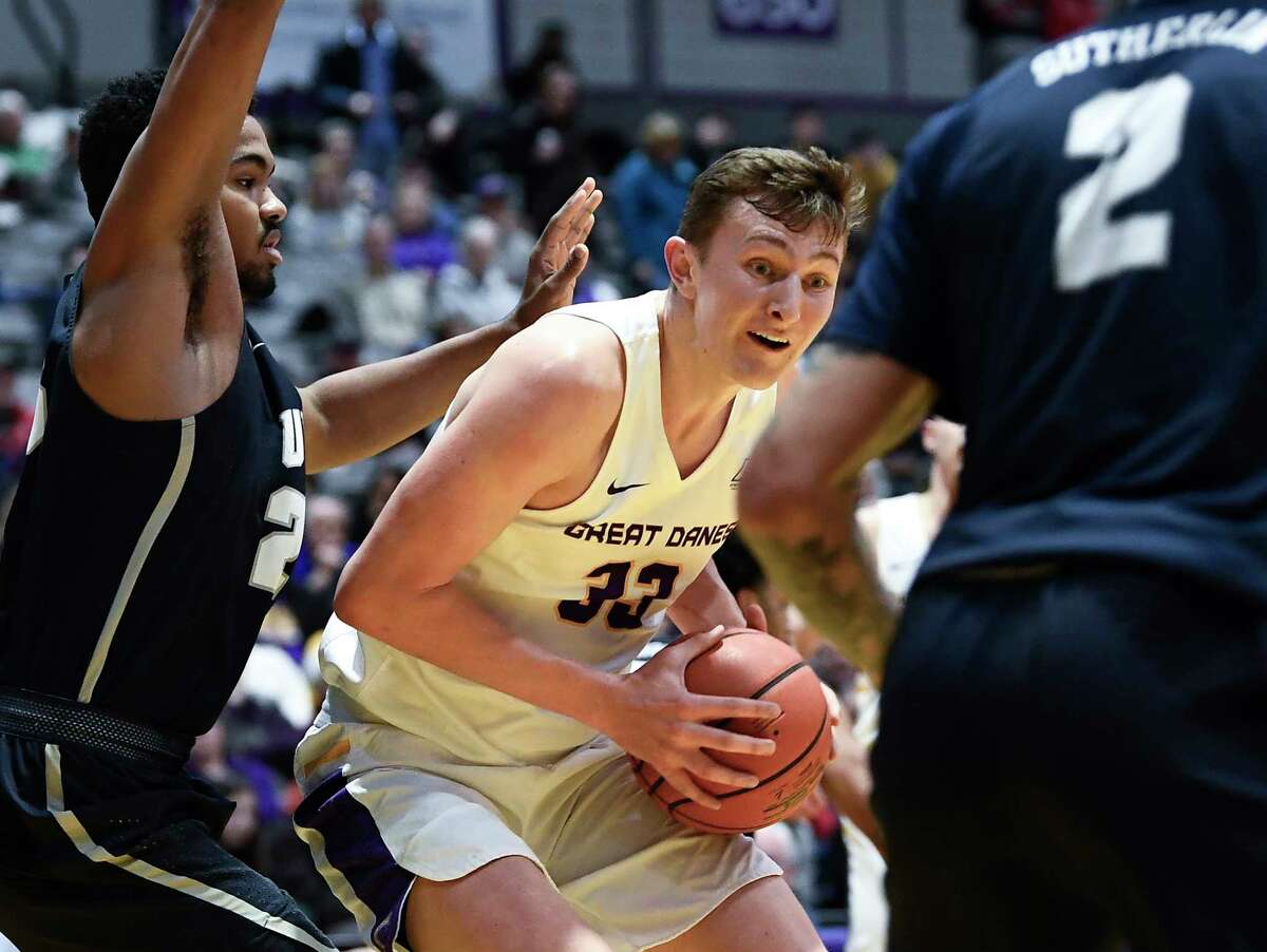 University at Albany forward Sasha French (33) moves the ball against New Hampshire defenders during the first half of an NCAA basketball game Saturday, Feb. 22, 2020, in Albany, N.Y.,