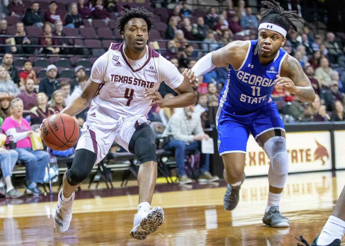 San Marcos, TX; Texas State Bobcats guard Shelby Adams (4) drives the ball to the basket as Georgia State Panthers guard Corey Allen (11) defends during the first half at the NCAA mens basketball game on Saturday, Feb 12, 2020, at the Strahan Arena. [JOHN GUTIERREZ/FOR EXPRESS-NEWS]