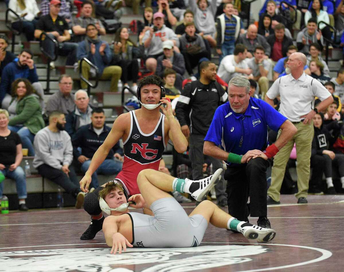 New Canaan's Tyler Sung pins Xavier's Quinn Moynihan to win the 152 pound weight class finals of the CIAC Class L Wrestling tournament on Feb. 22, 2020 at Bristol Central High School in Bristol, Connecticut.