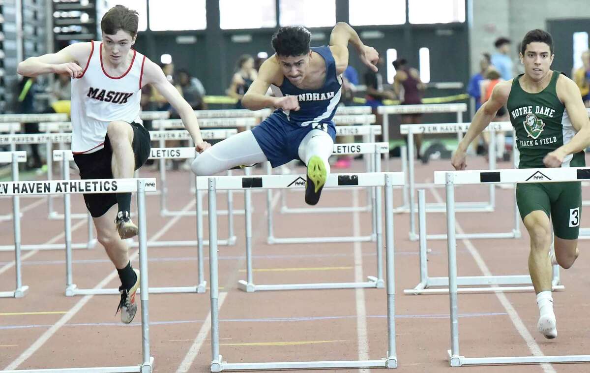 New Haven Connecticut - February 22, 2020: 55-meter hurdles champion Enrique Lopez Garcia of Windham H.S., center wins the preliminary race, center,during the CIAC State Open Indoor Track Championship Saturday at the Floyd Little Athletic Center in New Haven.