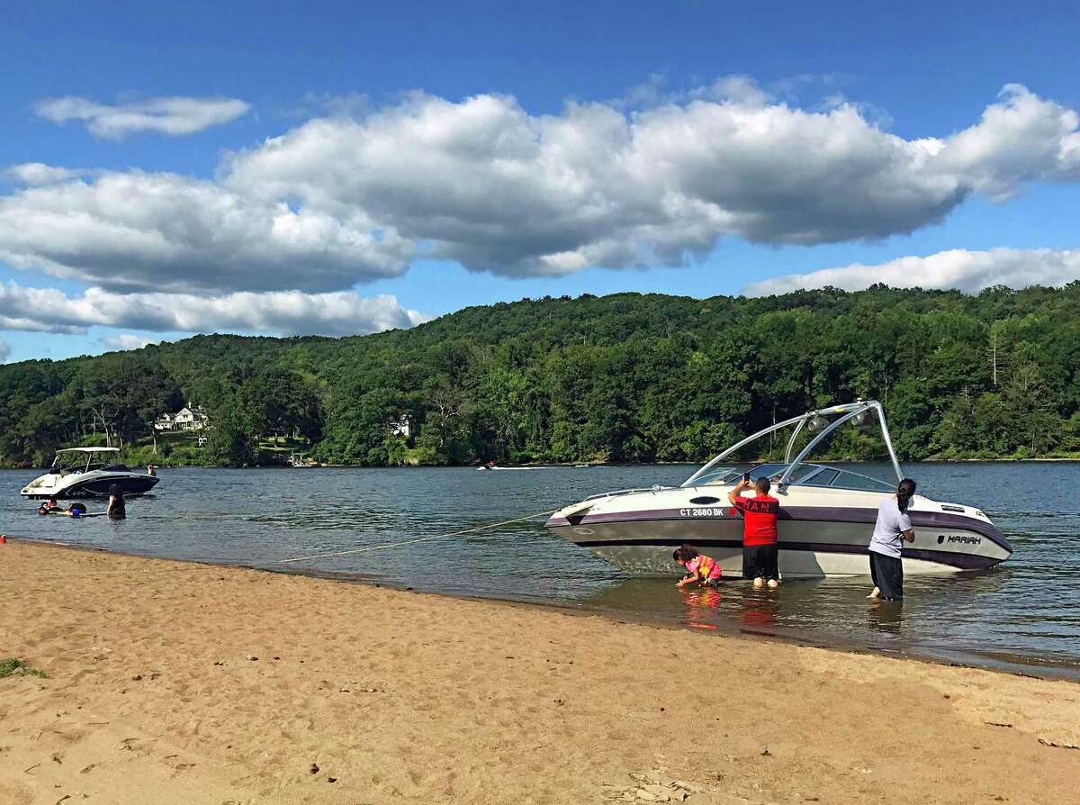 Boaters drop anchor along the large sandbar that forms at Haddam Meadows during low tide on the Connecticut River. Many enjoy socializing, picnicking and swimming during the warmer months.