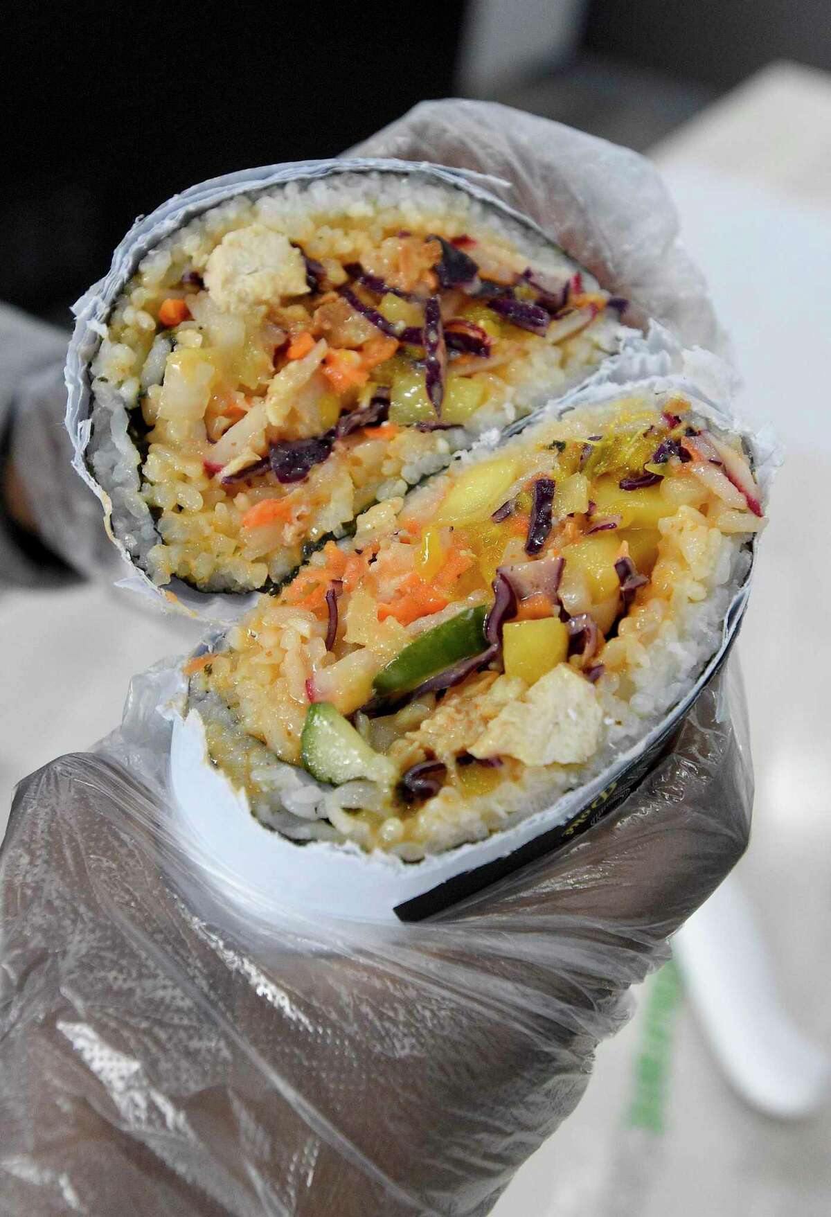 A poke burrito is displayed at Pokemoto on 229 Main St., in downtown Stamford, Conn., on Feb. 19, 2020.