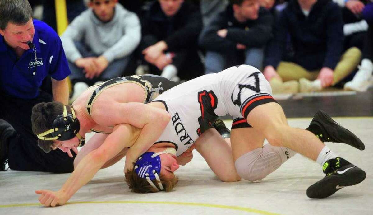 Trumbull's Jack Ryan looks to turn over Fairfield Warde's Nathan Cuoco during Class LL state championship wrestling finals action in Trumbull.