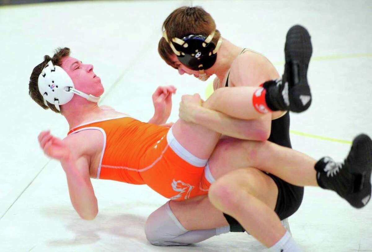 Trumbull's Michael Longo flips Ridgefield's Alexander Blaha during Class LL state championship wrestling finals action.