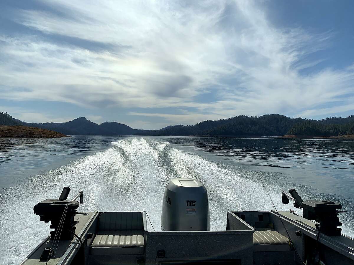 A clean wake across flat, calm water on a warm day at Shasta Lake gives rise to thoughts of spring for boating, camping and fishing