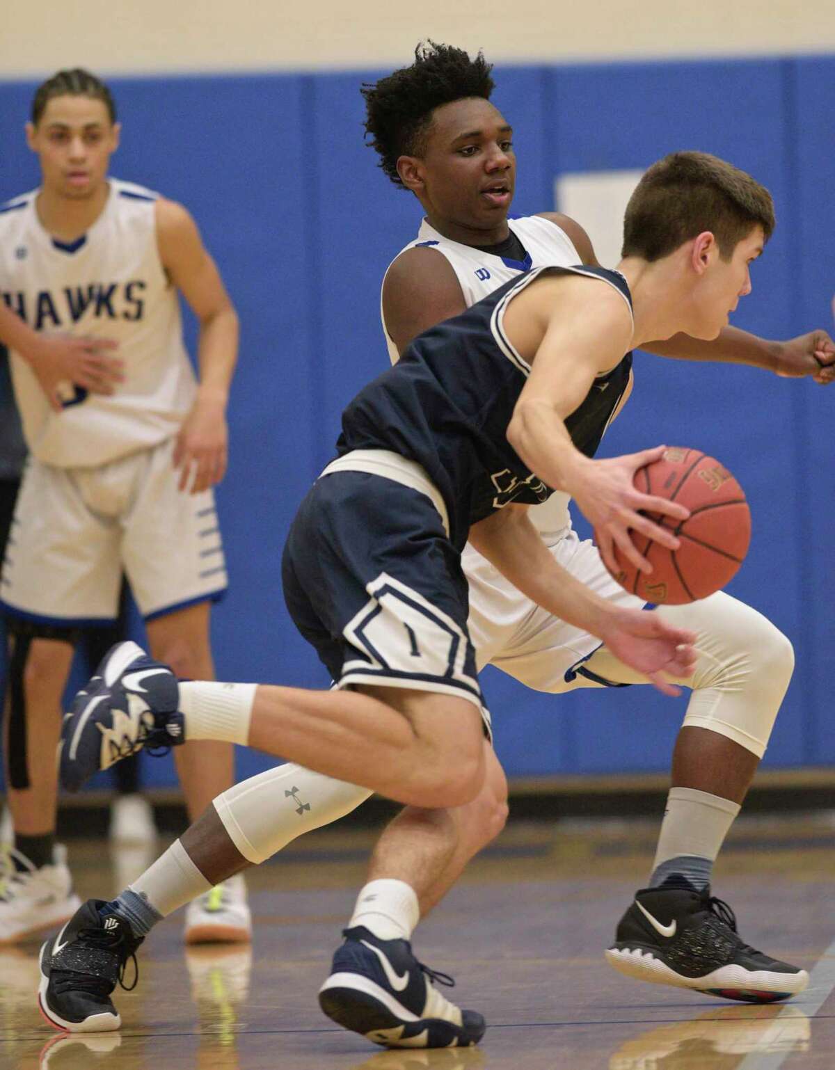 Immaculate’s Michael Iannetta, foreground, drives on Newtown’s Tyson Mobley during a game earlier this season.
