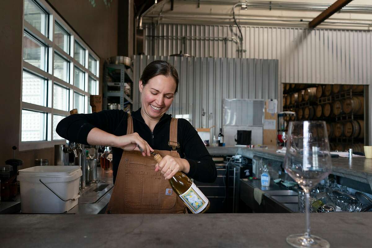Martha Stoumen opens a bottle of wine where she works in Sebastopol, California.