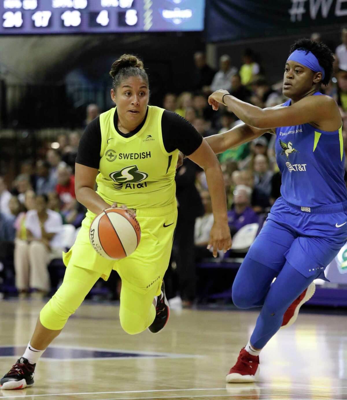 Seattle Storm's Kaleena Mosqueda-Lewis, left, drives past Dallas Wings' Kaela Davis during the second half of a WNBA basketball game Friday, July 12, 2019, in Seattle. Mosqueda-Lewis led the Storm with 18 points in their 95-81 victory. (AP Photo/Elaine Thompson)