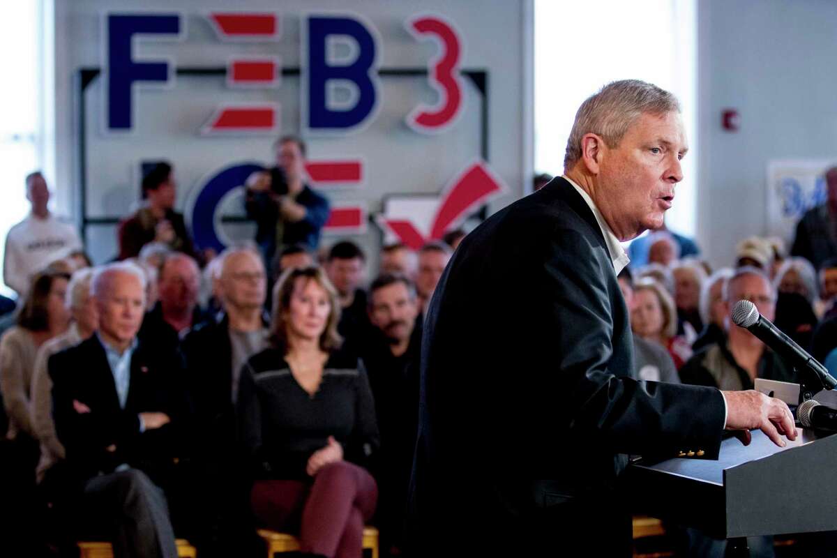 Democratic presidential candidate former Vice President Joe Biden, left, listens as Former United States Secretary of Agriculture Tom Vilsack speaks at a campaign stop at the LOFT on Jefferson, Friday, Jan. 31, 2020, in Burlington, Iowa. Vilsack has been named the new monitor of bankrupt OxyContin maker Purdue Pharma.