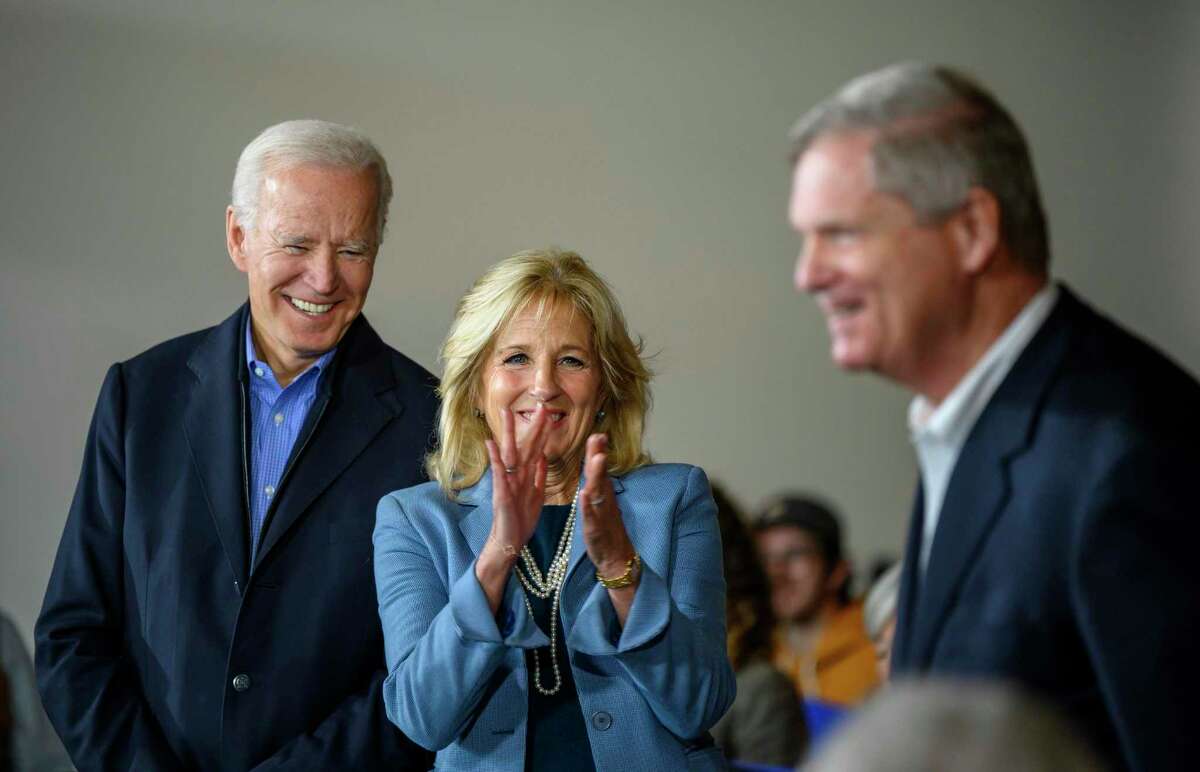 Democratic presidential candidate former Vice President Joe Biden and wife Jill Biden look on as former Iowa Governor and former Secretary of Agriculture Tom Vilsack is introduced before endorsing Biden during an event, Saturday, Nov. 23, 2019, in Des Moines, Iowa. Vilsack has been named the new monitor of bankrupt OxyContin maker Purdue Pharma.