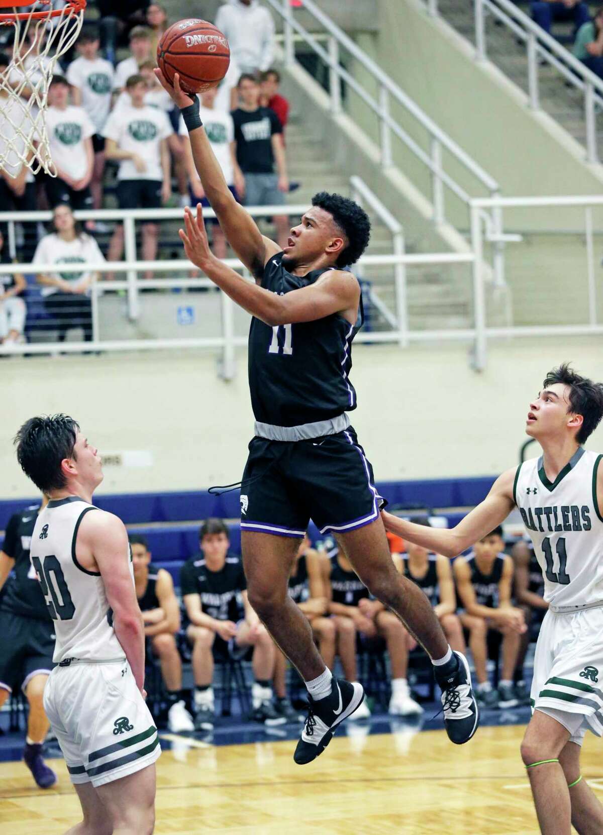 Kino Rodriguez-Thompson gets to the lane for a layup as Warren plays Reagan in boys basketball playoff action at Taylor Field House on Feb. 24, 2020.