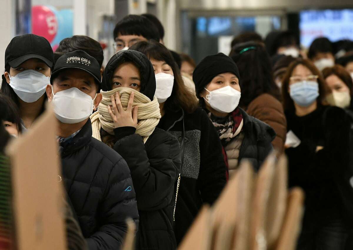 People wait in a line to buy face masks at a retail store in the southeastern city of Daegu on February 25, 2020. - South Korea reported 60 more COVID-19 coronavirus cases on February 25, the smallest increase for four days in the Korea Centers for Disease Control and Prevention's morning updates. The country now has 893 cases. (Photo by Jung Yeon-je / AFP) (Photo by JUNG YEON-JE/AFP via Getty Images)
