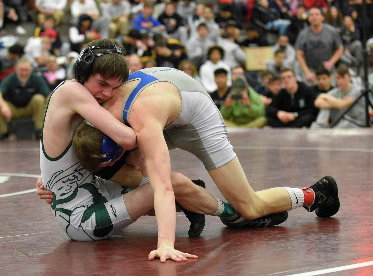 New Milford’s Evan Linder wrestles Bristol Eastren’s Trent Thompson in the 106-pound weight class finals of the Class L tournament on Saturday in Bristol.