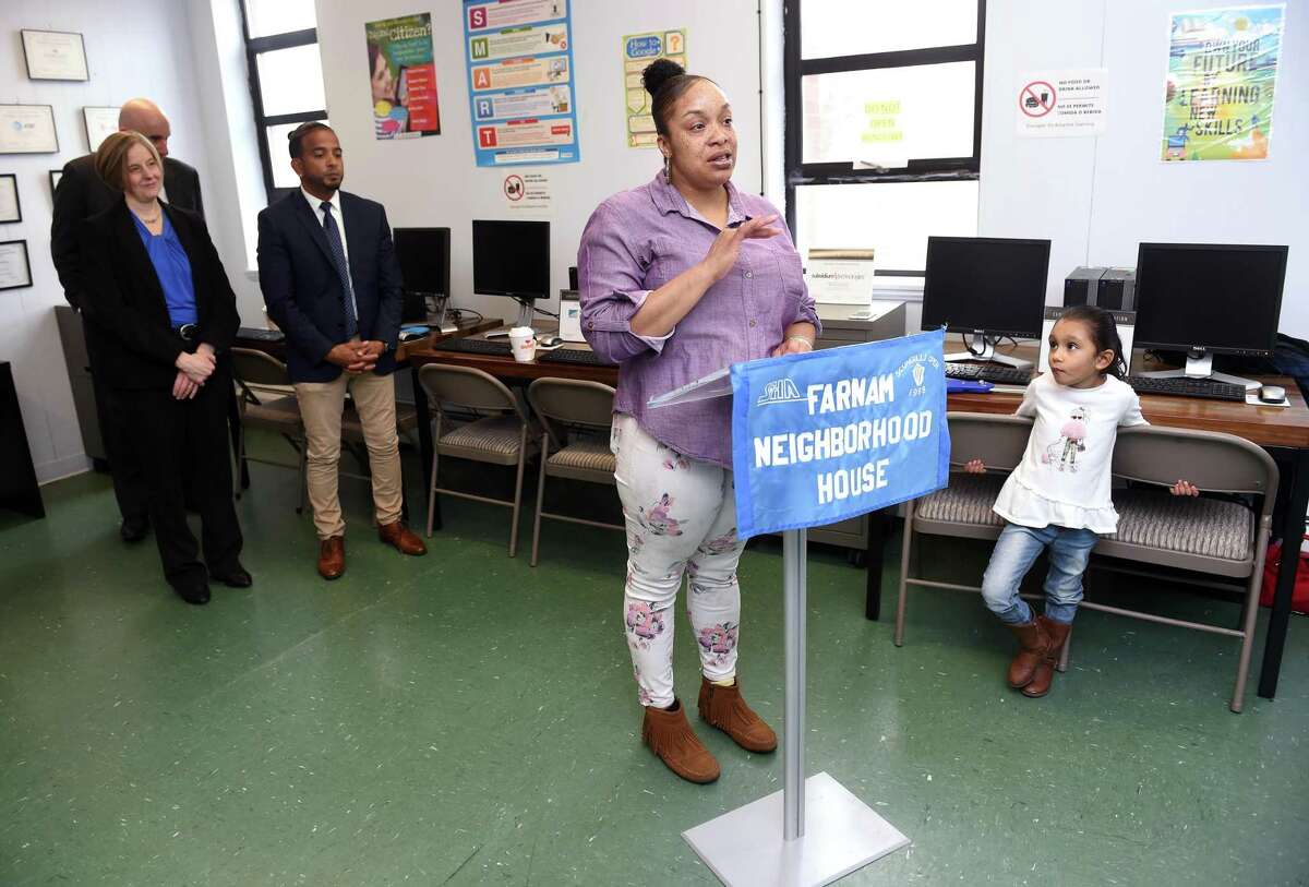 Preschooler Sophia Ortiz (right), 5, listens to Shalonda Sanders of New Haven speak during a ribbon cutting ceremony for the Curtis Hill Computer Center at the Farnam Neighborhood House in New Haven on February 25, 2020. Sanders was given a computer after completing a six-week computer class at the Farnam Neighborhood House which partnered with Concepts for Adaptive Learning. About 10 people per month compete the program at this location.