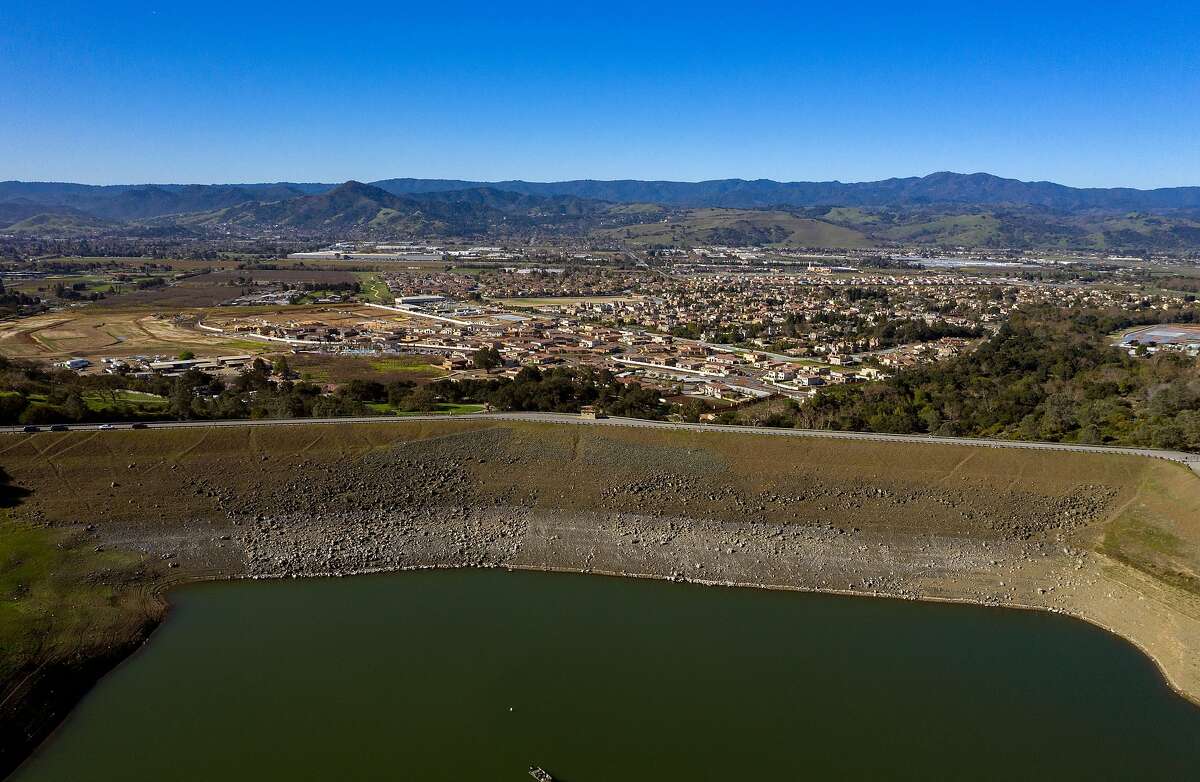 An aerial view of the dam and at homes below it at Anderson Lake Reservoir on Tuesday, Feb. 25, 2020 in Morgan Hill, Calif.