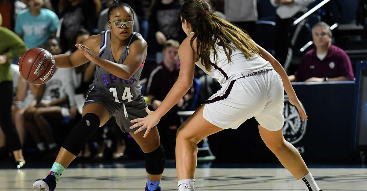 Ridge Point junior guard Aleighyah Fontenot (14) works the ball against the defense of Cy-Fair sophomore Olaia Arenas, right, during the 4th quarter of their Region III-6A Quarterfinal playoff matchup at Delmar Fieldhouse on Tuesday, Feb. 25, 2020.