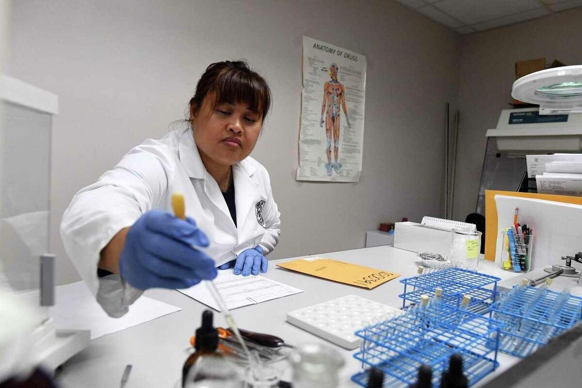 Yvette Pirkle, a forensic scientist at the Bexar County Crime Lab in its drug identification section, works on samples Tuesday.