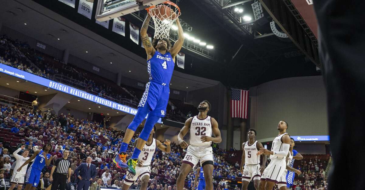 Kentucky forward Nick Richards (4) dunks over Texas A&M forward Josh Nebo (32) during the first half of an NCAA college basketball game Tuesday, Feb. 25, 2020, in College Station, Texas. (AP Photo/Sam Craft)