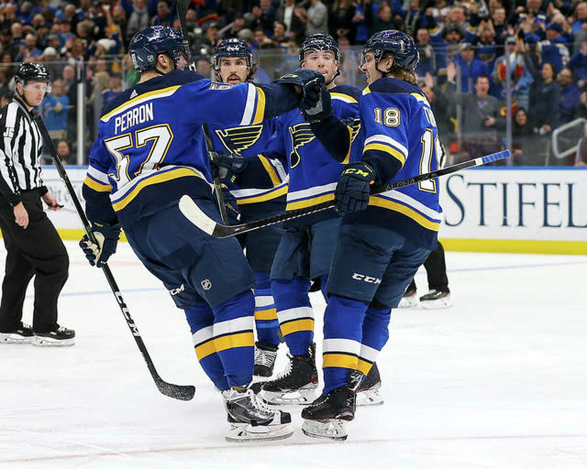 The Blues’ Robert Thomas (18), right, is congratulated by teammate David Perron (57) after scoring a goal in the second period of Tuesday night’s game against the Chicago Blackhawks in St. Louis.