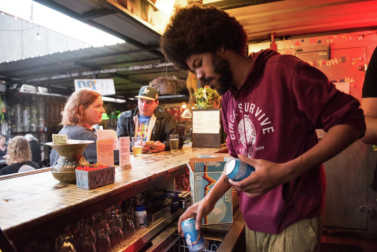 Eli's bartender Malik Mays stocks a cooler to the brim with cans of Montucky.