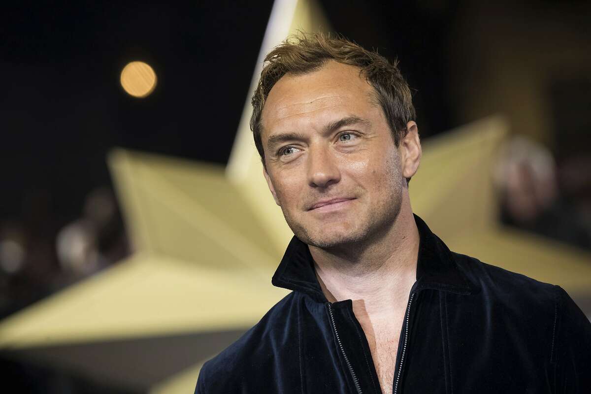 FILE - In this Feb. 27, 2019 file photo, actor Jude Law poses for photographers upon arrival at the premiere of the film 'Captain Marvel', in London. Law is among the readers in an all-star recording of J.K. Rowling's “The Tales of Beedle the Bard," the first time her Harry Potter spinoff has been available as an audio book. (Photo by Vianney Le Caer/Invision/AP, File)