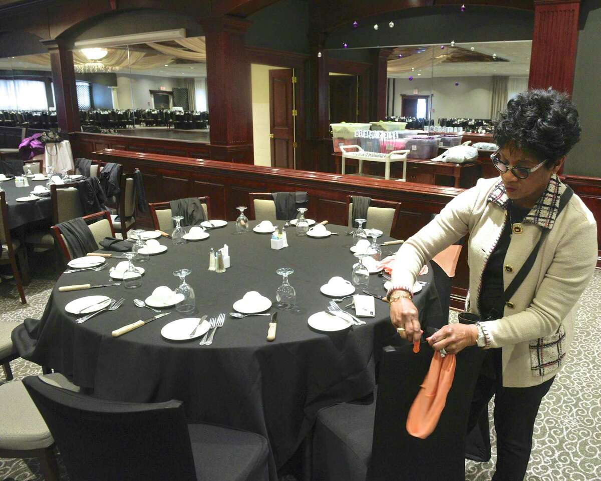 Shauna Baker, decorations chairwoman, readies a table for the Hord Foundation Wednesday as it prepares for its 27th annual gala Saturday at the Amber Room Colonnade in Danbury.