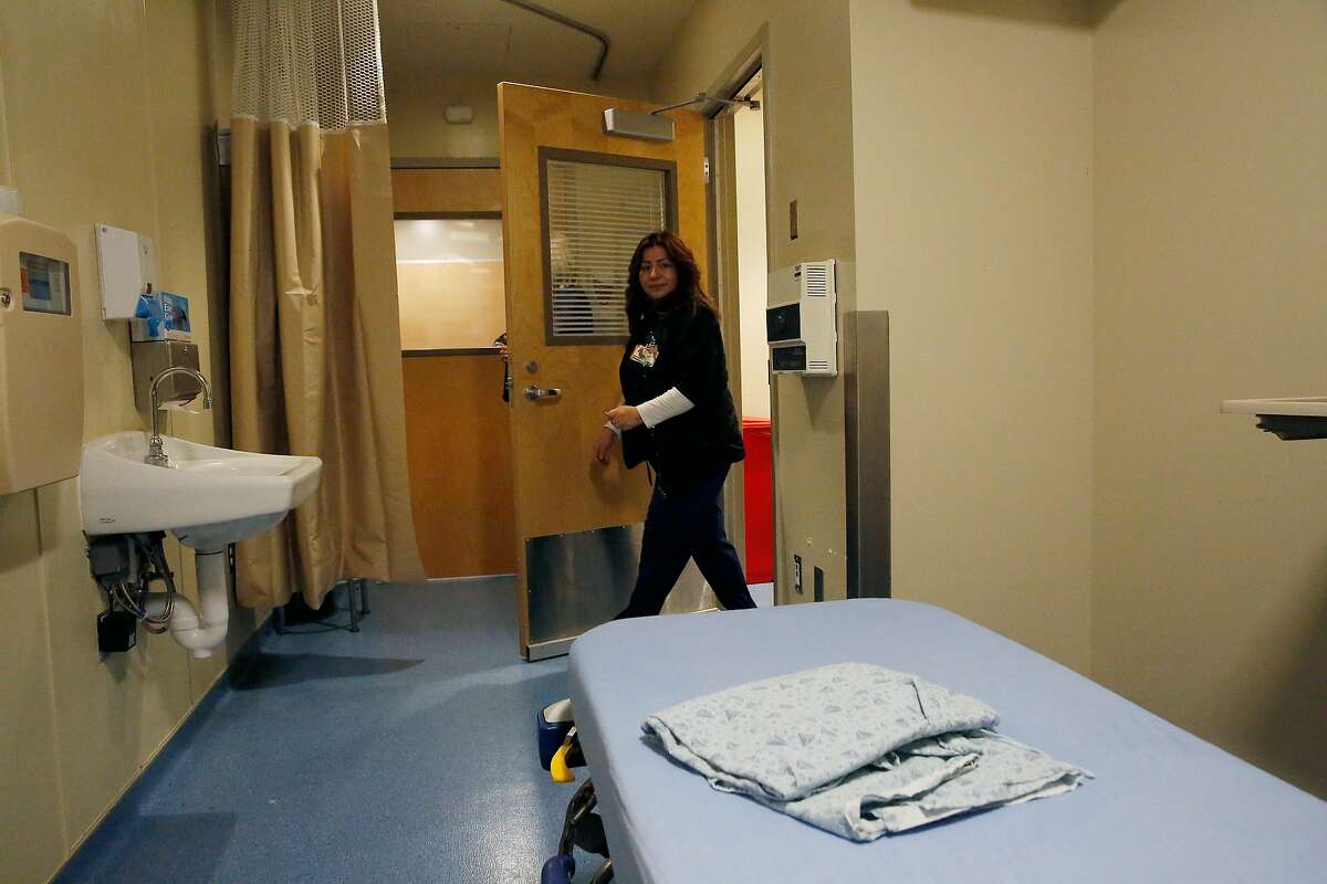 Maggie Murillo, quality data analyst, enters a negative pressure treatment room via a door to an anteroom at Saint Francis Memorial Hospital on Tuesday, February 4, 2020 in San Francisco, Calif.