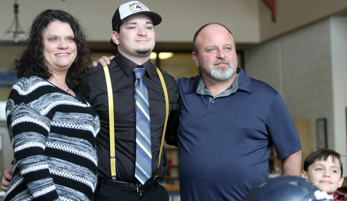 North Huron's Chris Augle poses with his family after signing his letter of intent on Wednesday morning.