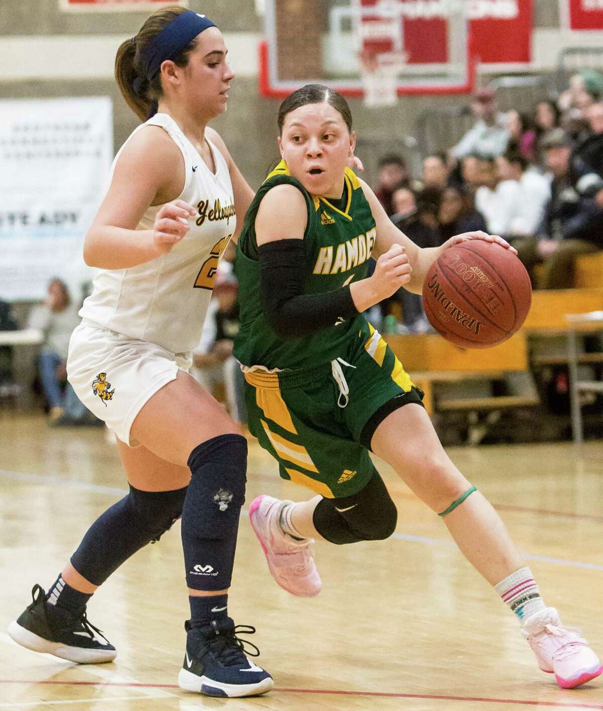 Hamden’s Asya Brandon drives the lane past East Haven defender Isabella Ragaini during the SCC championship game on Wednesday.