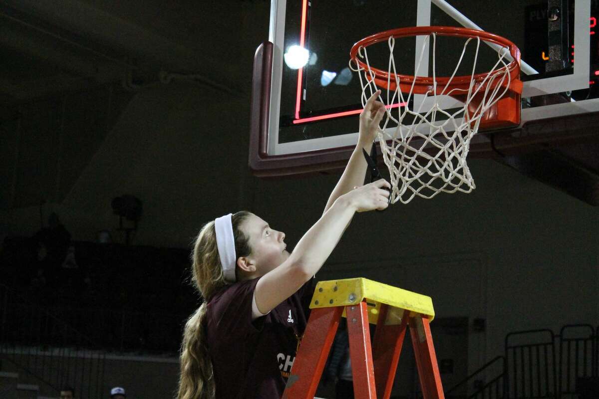 CMU's Molly Davis cuts down a piece of netting at McGuirk Arena following the Chippewas' 76-60 win over Western Michigan on Wednesday.