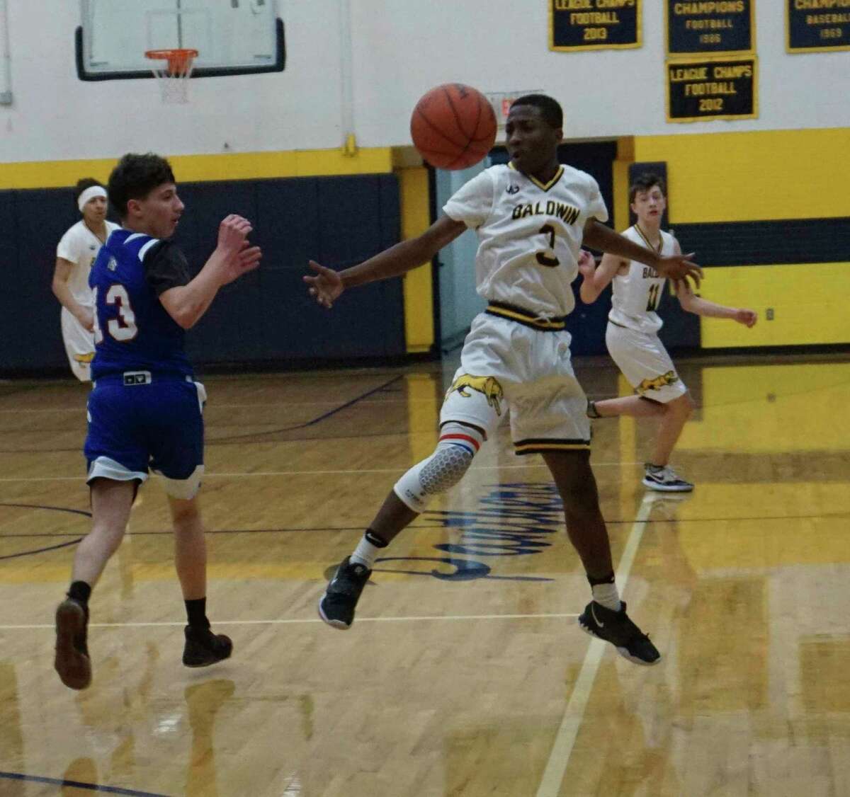 Baldwin's Carmelo Lindsey adjusts mid-air while intercepting a pass during the Panthers' victory over Charlton Heston Academy on Monday evening. (Star photo/Joe Judd)