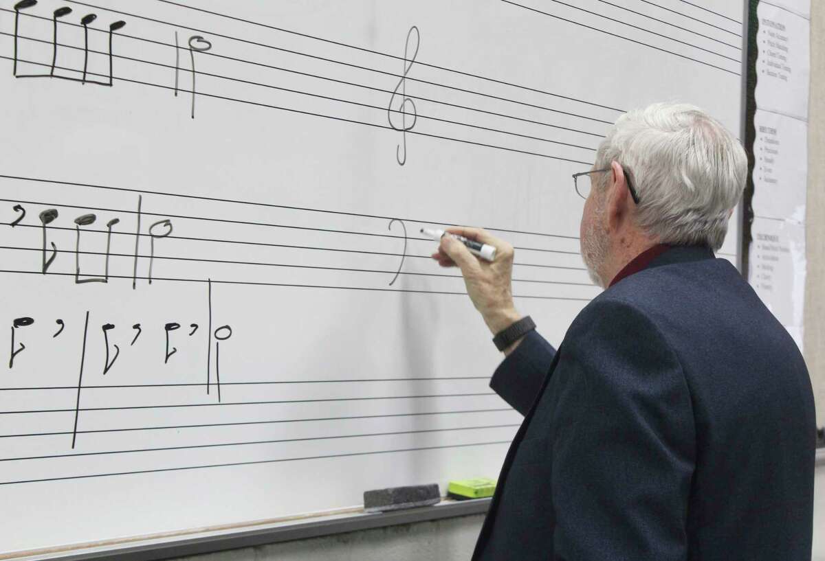 During class, Bass writes on the white board. He said he prefers to give students a visual aid during practice. (Star photo/Catherine Sweeney)