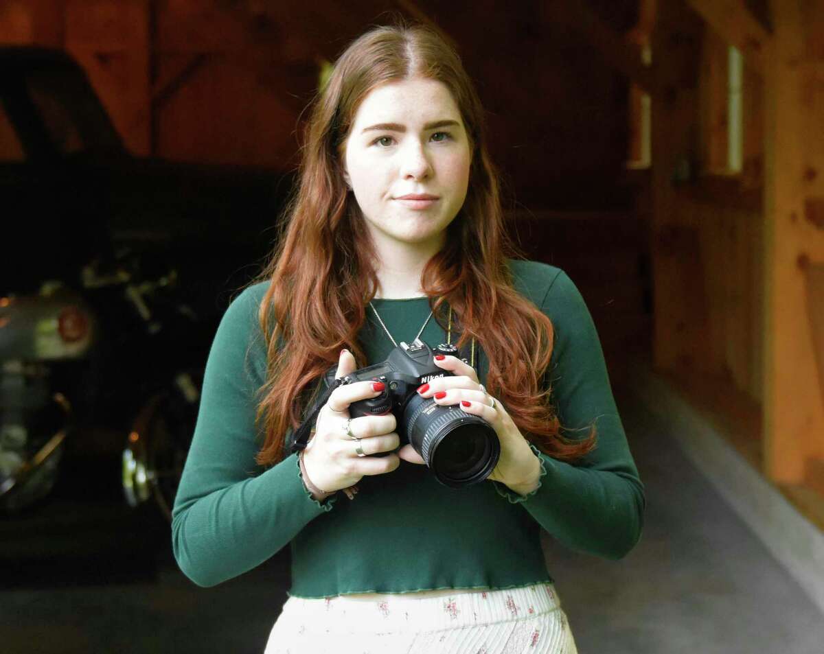 Greenwich artist Sutton Brown Mock poses with her camera at her home in Greenwich, Conn. Wednesday, July 10, 2019.