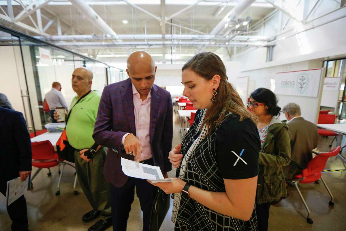 Adviser and sales expert Rohan Bairat talks with Emily Reiser, senior manager of innovation community engagement at the Texas Medical Center, during the TMCx accelerator’s new two-week bootcamp Tuesday, Feb. 25, 2020, in Houston.