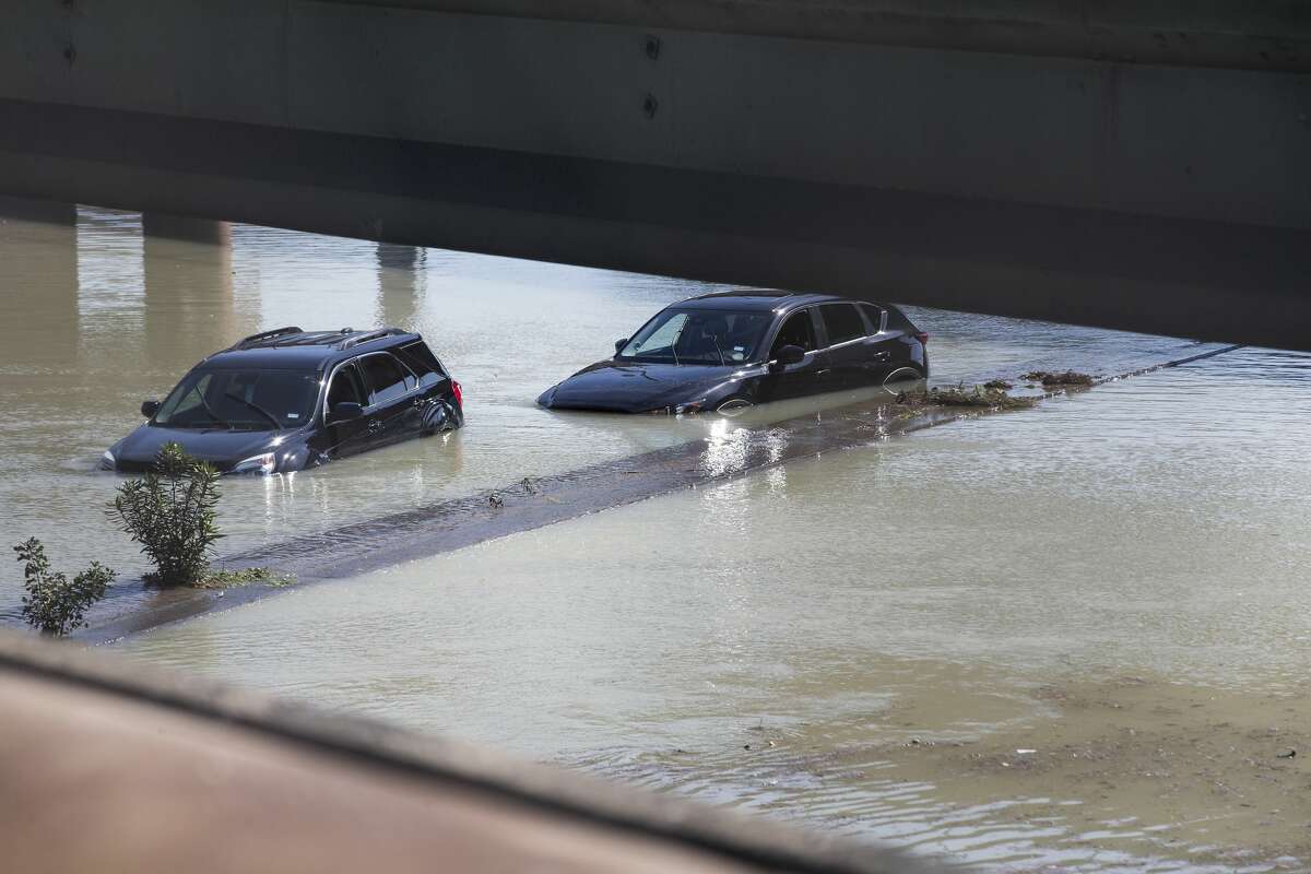 Abandoned vehicles sit stalled in floodwaters from a water main break that inundated the East Loop 610, closing the major freeway that circles the city on Thursday, Feb. 27, 2020 in Houston.