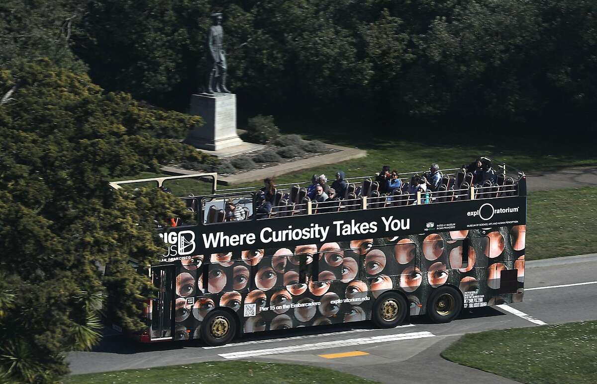 A tour bus drives through Golden Gate Park on Wednesday, Feb. 26, 2020, in San Francisco, Calif.