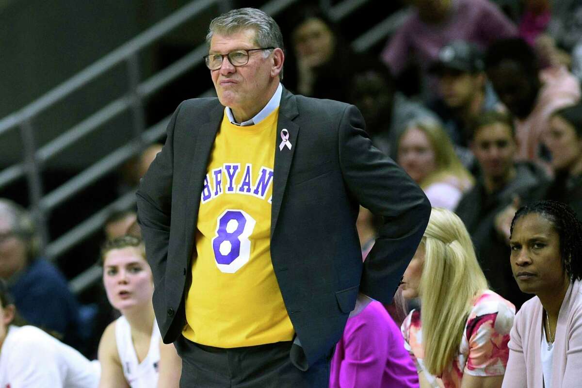 UConn coach Geno Auriemma wears a jersey honoring late NBA star Kobe Bryant as watches play from the sideline in February.