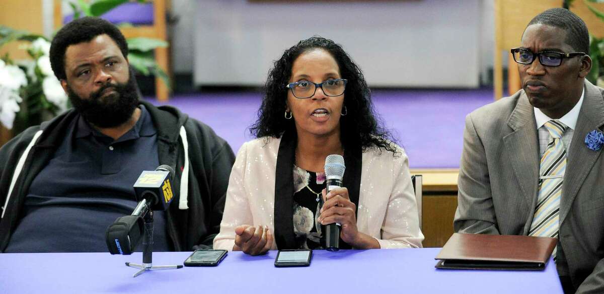 Steven Barrier Sr., at left, and Rev. Robert Jackson, at right, listen as Valerie Jaddo, mother of Steven Barrier, reads a prepared statement during a press conference at Bethel AME Church in Stamford on Oct. 25, 2019, regarding the incident with her son and the Stamford Police Department. Clergy, community leaders and the Stamford NAACP along with family members release of information into what happen.