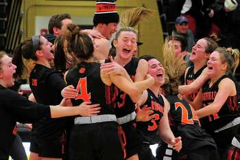 Ridgefield celebrates after beating Staples to win the FCIAC girls basketball championship on Feb. 27, 2020.