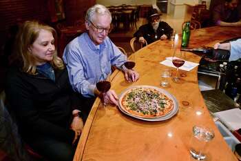 Westport residents and longtime patrons Rick and Ruth Edelson enjoy pizza and wine at the Fat Cat Pie Co. on Wall Street Wednesday, Feb. 12, in Norwalk. The pizza restaurant and wine bar has announced that it will be closing after 16 years in the Twin City Building on Wall Street.
