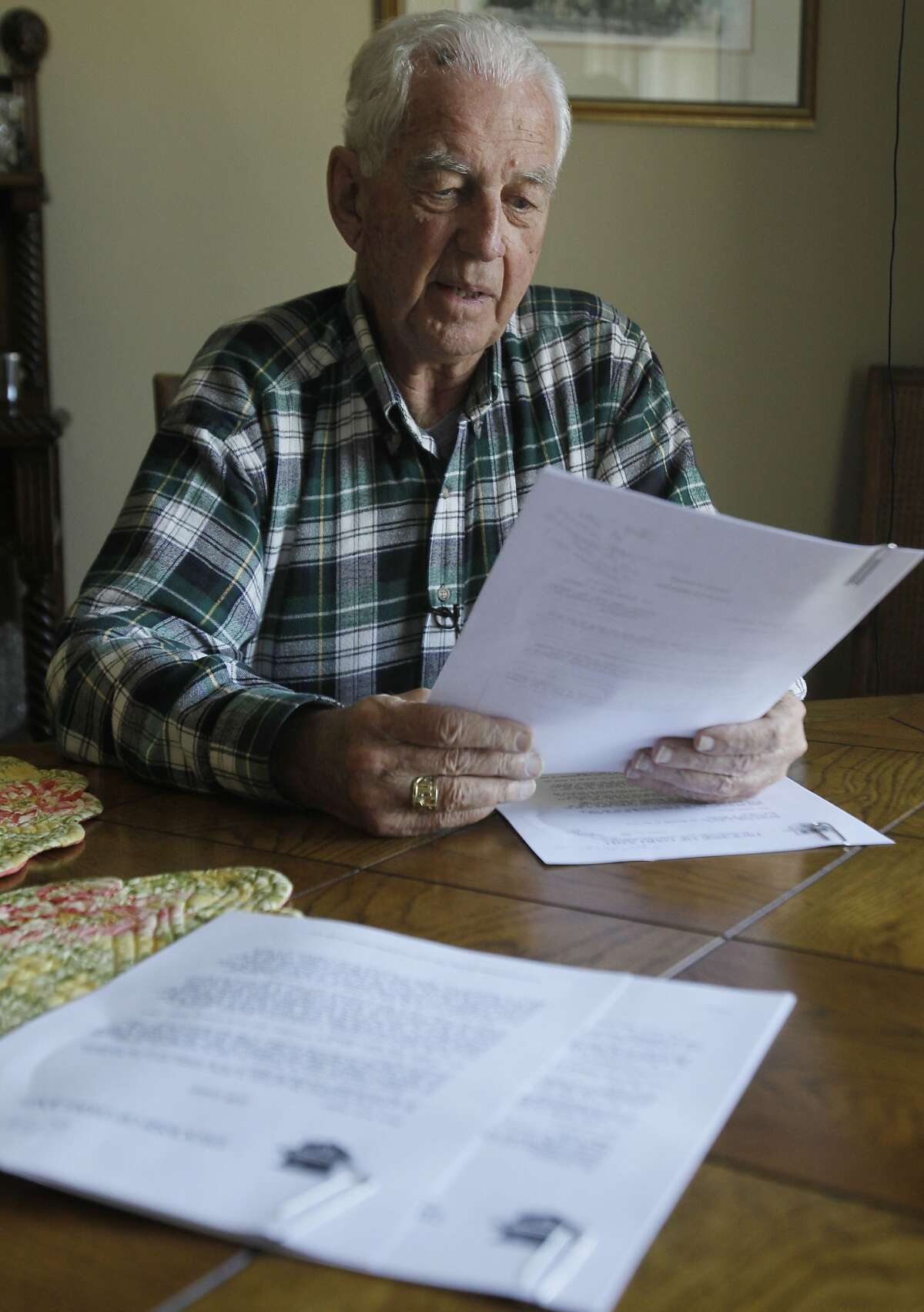 John S. Cummins, former bishop of the diocese of Oakland, Calif., recalls correspondence from Cardinal Joseph Ratzinger regarding troubled priest Stephen Kiesle as he looks over copies of a document brought by the Associated Press to his home in Oakland,