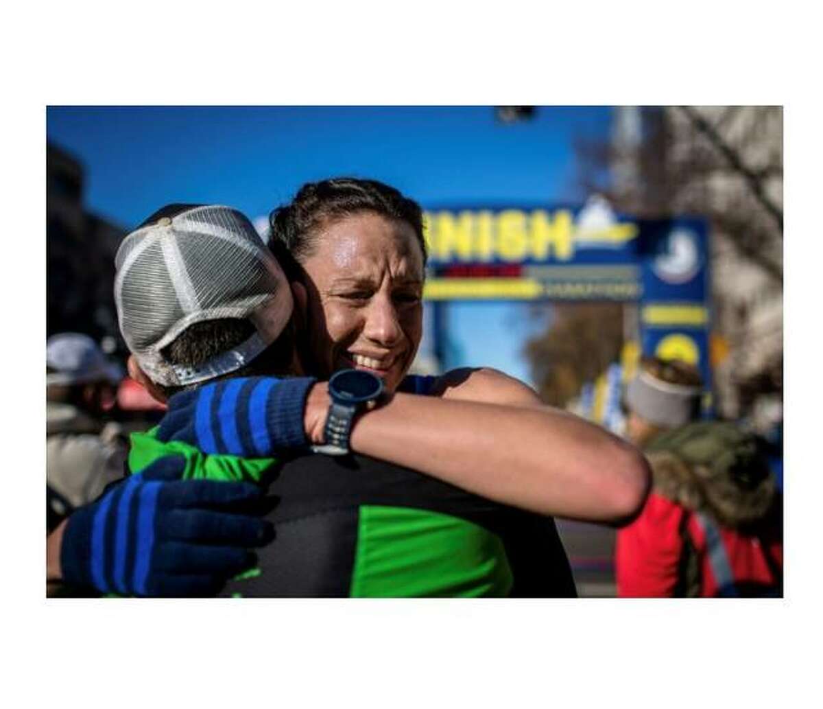 Edwardsville resident Crystal Harriss, right, hugs her coach, James McKirdy, after finding out that her time of 2:44.49 in the California International Marathon on Dec. 2, 2018, qualified her for the U.S. Olympic Marathon Trials, scheduled for Saturday in Atlanta.