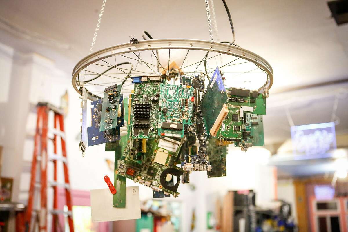 A chandelier made from a bicycle wheel and circuit boards is seen at Noisebridge on Tuesday, July 24, 2018 in San Francisco, California.