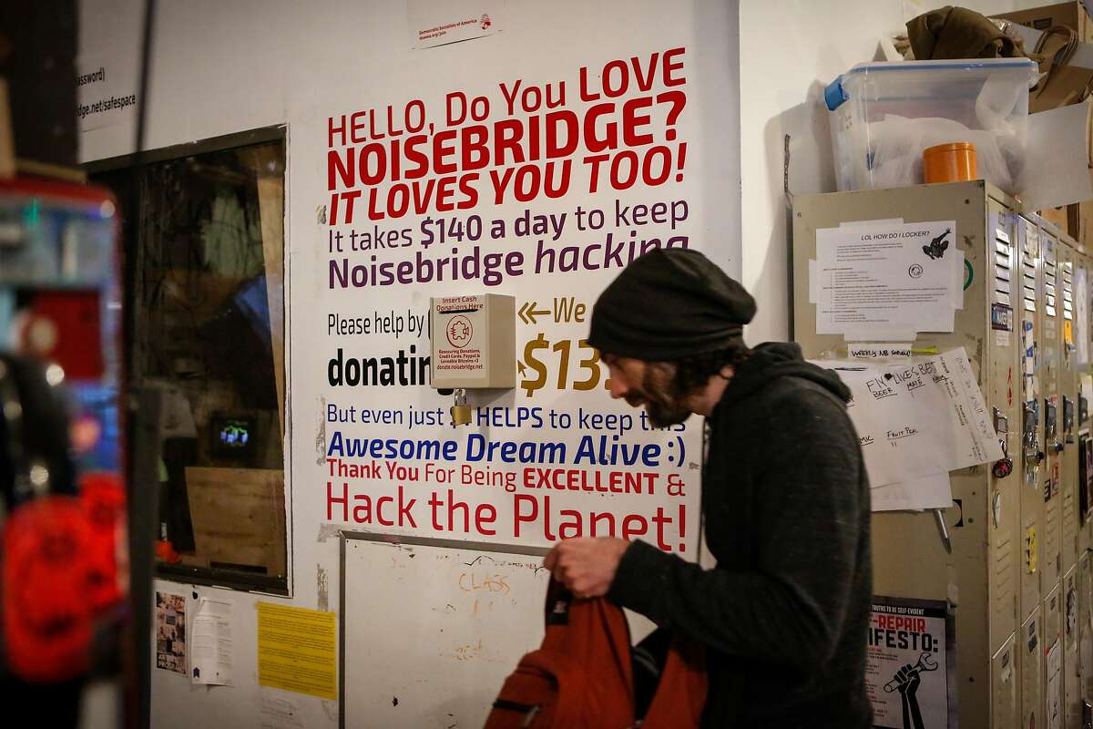 A man walks past a sign on the wall at Noisebridge on Tuesday, July 24, 2018 in San Francisco, California. Noisebridge, a nonprofit, is fully funded mostly by donations from its members.