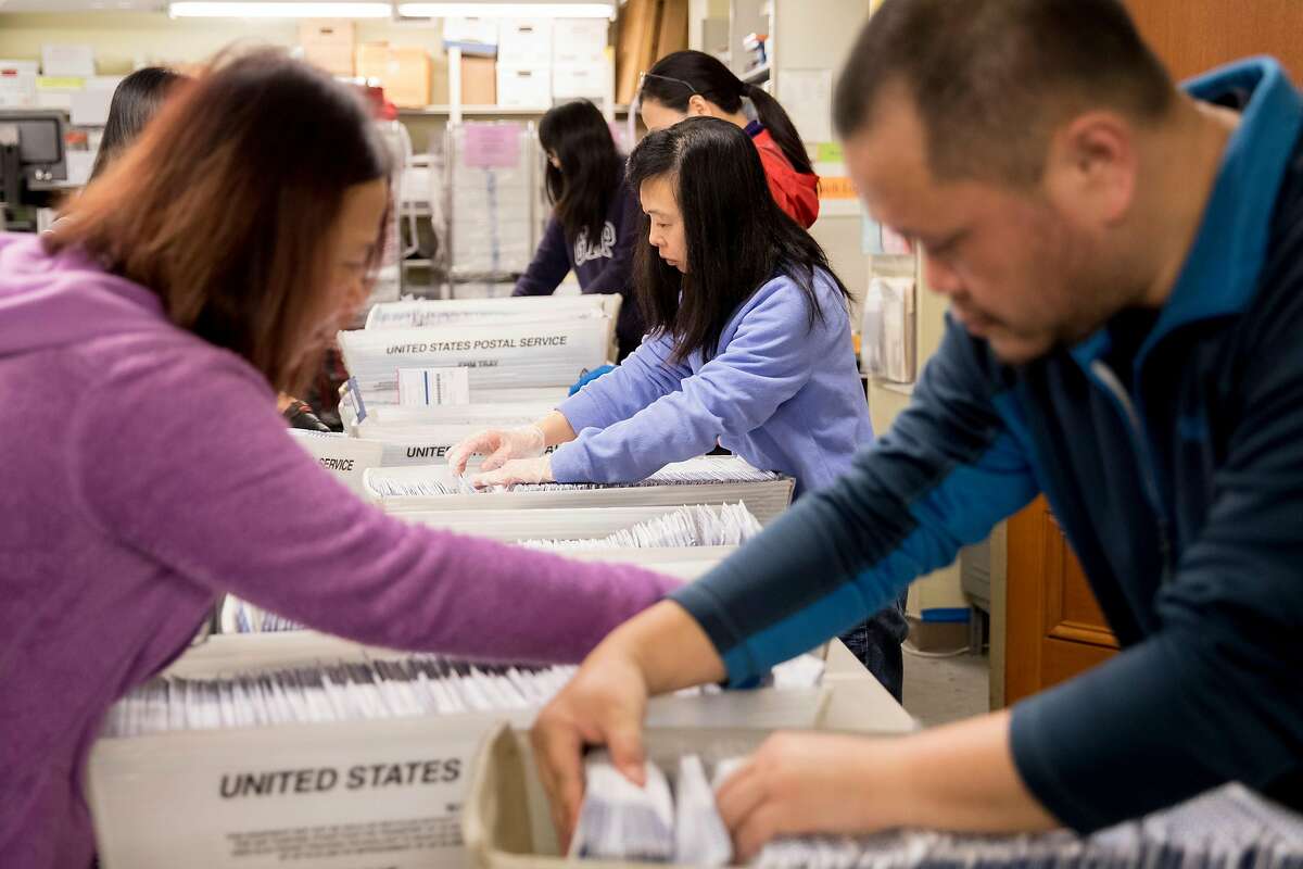 Election staff work to sort through vote-by-mail ballots that arrived ahead of the March 3rd election at San Francisco City Hall in San Francisco, Calif. Friday, February 28, 2020.