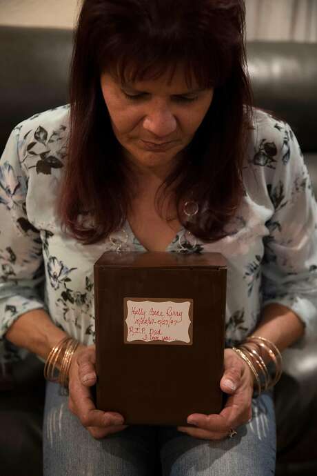 Melissa Moore, ex-fiance of Kelly Gene Perry, holds a container with his ashes at her home in Castro Valley, Calif., on Tuesday, February 18, 2020.  Perry’s body was recently identified through forensic genealogy after his dismembered body was found 22 years ago in Livermore months after he went missing. The body was too decomposed to be identified until new technology allowed a positive match, and police are reexamining the cold case following the identification. Photo: Carlos Avila Gonzalez / The Chronicle